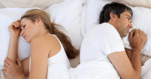 upset couple sleeping separately