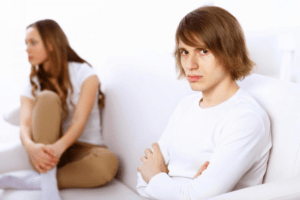 A couple sitting unhappily due to an argument.