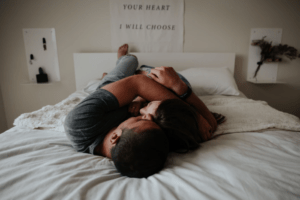 Young, loving couple in bed.