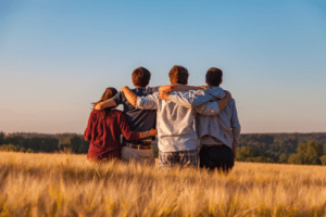 Family huddling in a field.