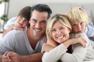 Happy couple with children smiling during a counseling session in Portland