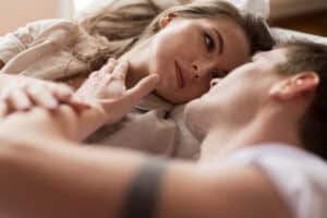 Married couple sharing quiet eye contact and gentle touch, symbolizing emotional intimacy, trust, and connection in marriage.